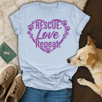 Light blue t-shirt with purple "Rescue. Love. Repeat." text and paw prints.