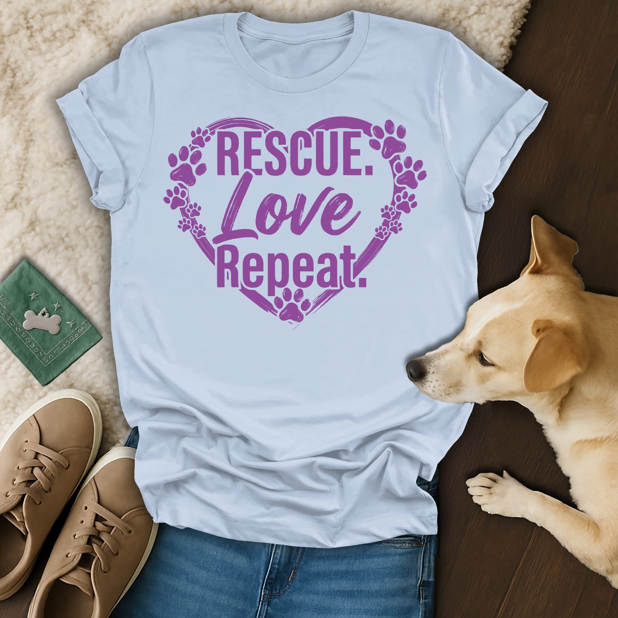Light blue t-shirt with purple "Rescue. Love. Repeat." text and paw prints.