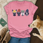 Four dogs wearing beanies on a pink t-shirt.