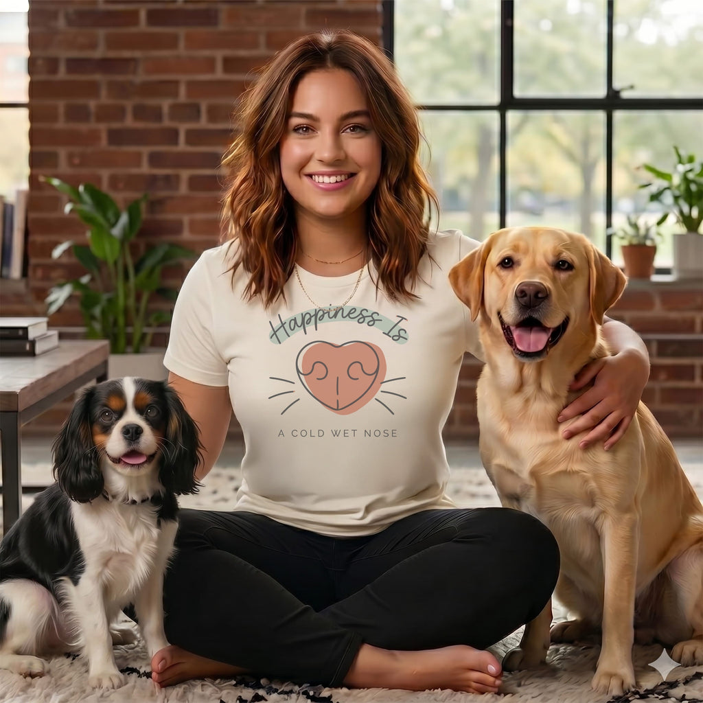 Woman with two dogs, wearing a shirt that says "Happiness Is A Cold Wet Nose".