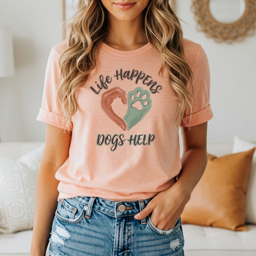 Peach t-shirt with "Life Happens Dogs Help" text, heart, and paw print graphic.