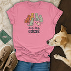 Pink t-shirt with cartoon dogs and a duck, text reads "dog, dog, GOOSE".