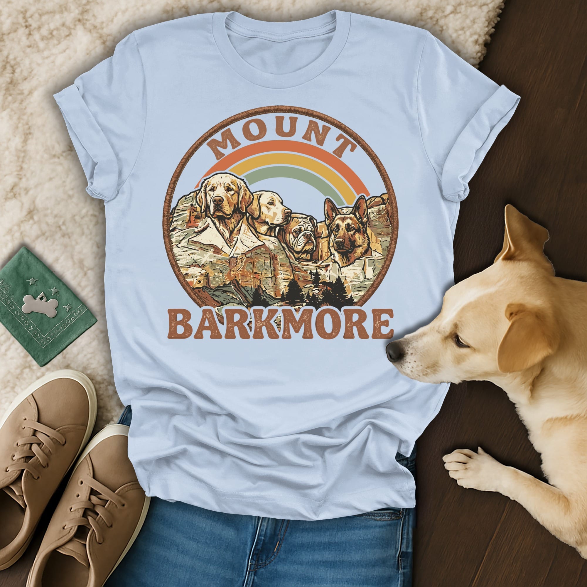 Mount Barkmore graphic with dogs and rainbow on a light blue t-shirt.