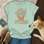 Light blue t-shirt with puppy, paw print flowers, butterflies, and "Happiness Grows Here" text.