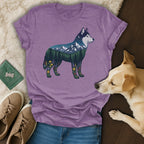 Husky silhouette filled with mountain landscape and wildflowers on purple t-shirt.