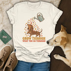 A cream t-shirt with a dachshund graphic and the text Grow Through What You Go Through.