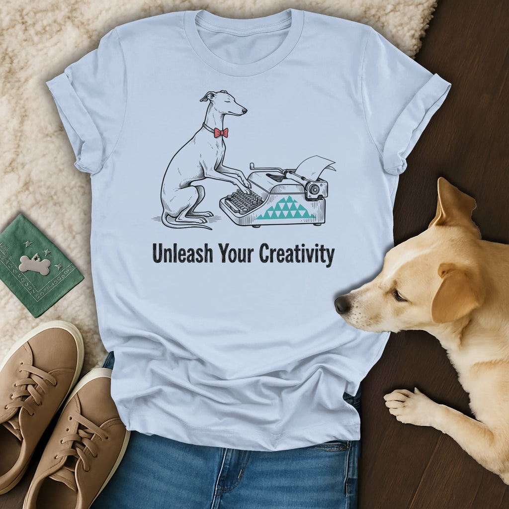 Light blue t-shirt with a dog typing on a typewriter, "Unleash Your Creativity."