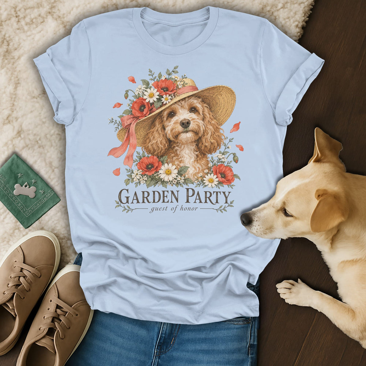 Light blue t-shirt featuring a graphic of a curly dog wearing a floral hat and the text GARDEN PARTY guest of honor.