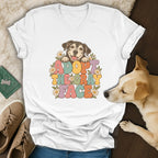 White v-neck t-shirt featuring a retro graphic of a happy dog and the text ADOPT THE GRAY FACE.
