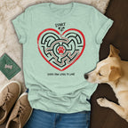 Light teal t-shirt with heart maze, paw prints, and text "Start" and "Every Paw Leads to Love".