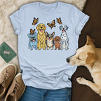 Lineup of four dogs with butterflies above them on a light blue t-shirt.