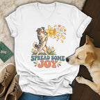 White V-neck t-shirt featuring a vintage-style graphic of an Australian Shepherd holding a daffodil with text reading SPREAD SOME JOY.