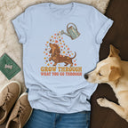 Light blue t-shirt featuring a dachshund graphic and the text GROW THROUGH WHAT YOU GO THROUGH.