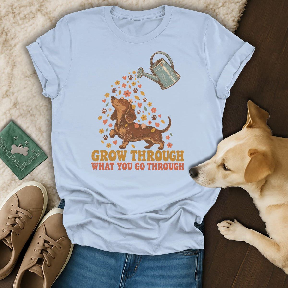 Light blue t-shirt featuring a dachshund graphic and the text GROW THROUGH WHAT YOU GO THROUGH.