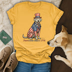 Yellow t-shirt with a dog wearing a patriotic hat and suit, text reads "Pawtriots Since 1776".