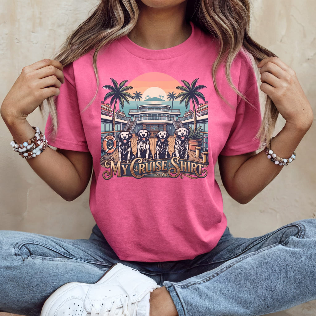 Pink t-shirt with graphic of dogs on a cruise ship deck with palm trees.