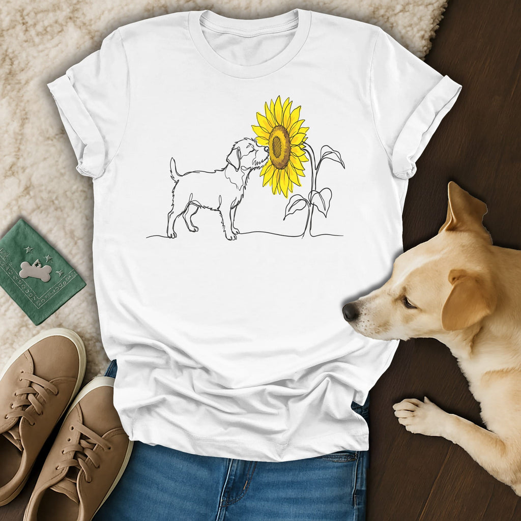 Line drawing of a dog sniffing a sunflower on a white t-shirt.