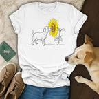 Line drawing of a dog sniffing a sunflower on a white t-shirt.
