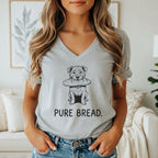 Line art dog with bread in mouth on light gray t-shirt with "PURE BREAD." text.