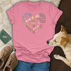 Pink t-shirt with a heart-shaped graphic of dog toys and accessories.
