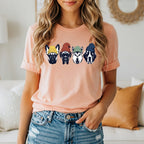Peach t-shirt with four cartoon dogs wearing beanies.