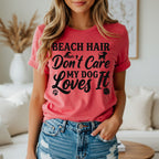 Coral t-shirt with "Beach Hair Don't Care My Dog Loves It" text and paw print.