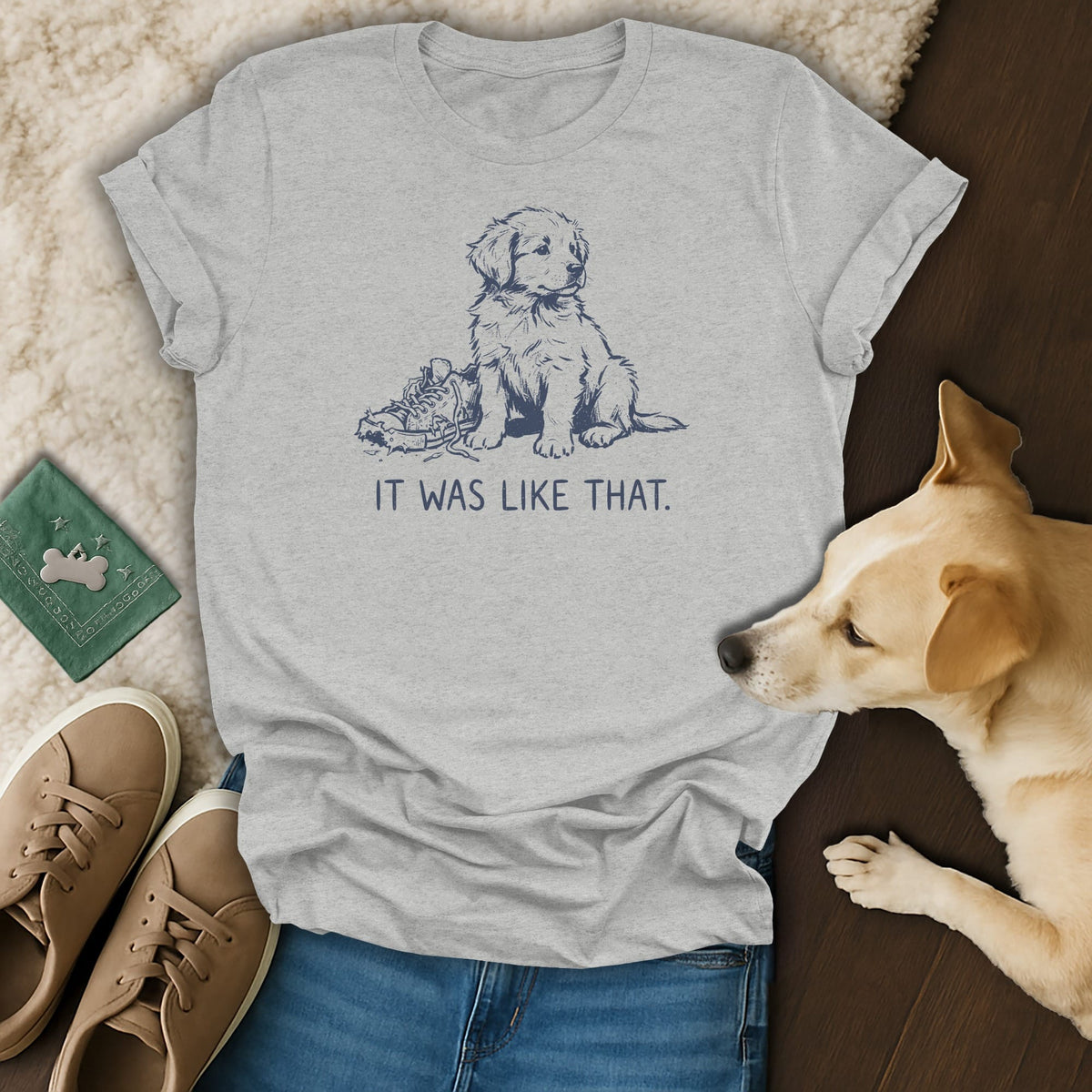 Light grey t-shirt with a dark blue line drawing of a puppy next to a shoe with text "IT WAS LIKE THAT."