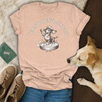 Light peach t-shirt with a dachshund in a cowboy hat on a robot vacuum.