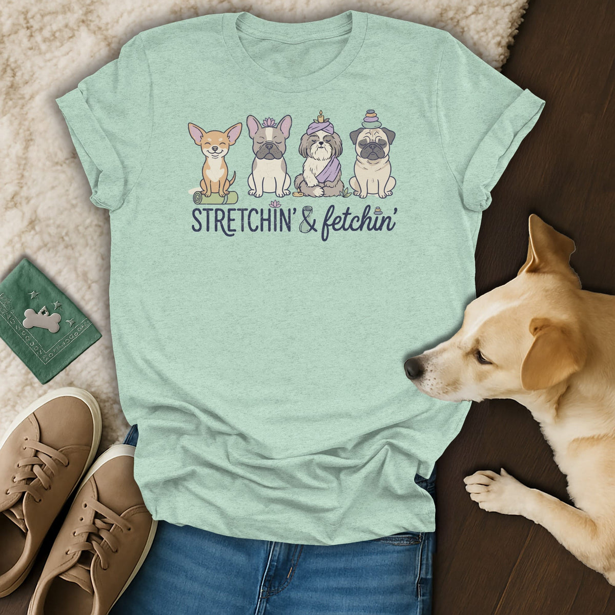 Light teal t-shirt with cartoon dogs sitting and text "STRETCHIN' & fetchin'".