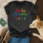 Black t-shirt with "love has four paws" text and paw prints.