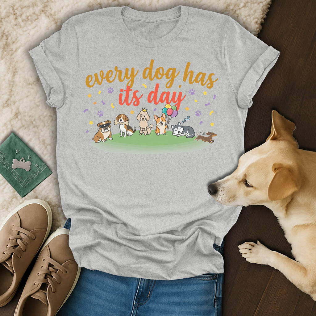 Grey t-shirt with cartoon dogs and "every dog has its day" text.