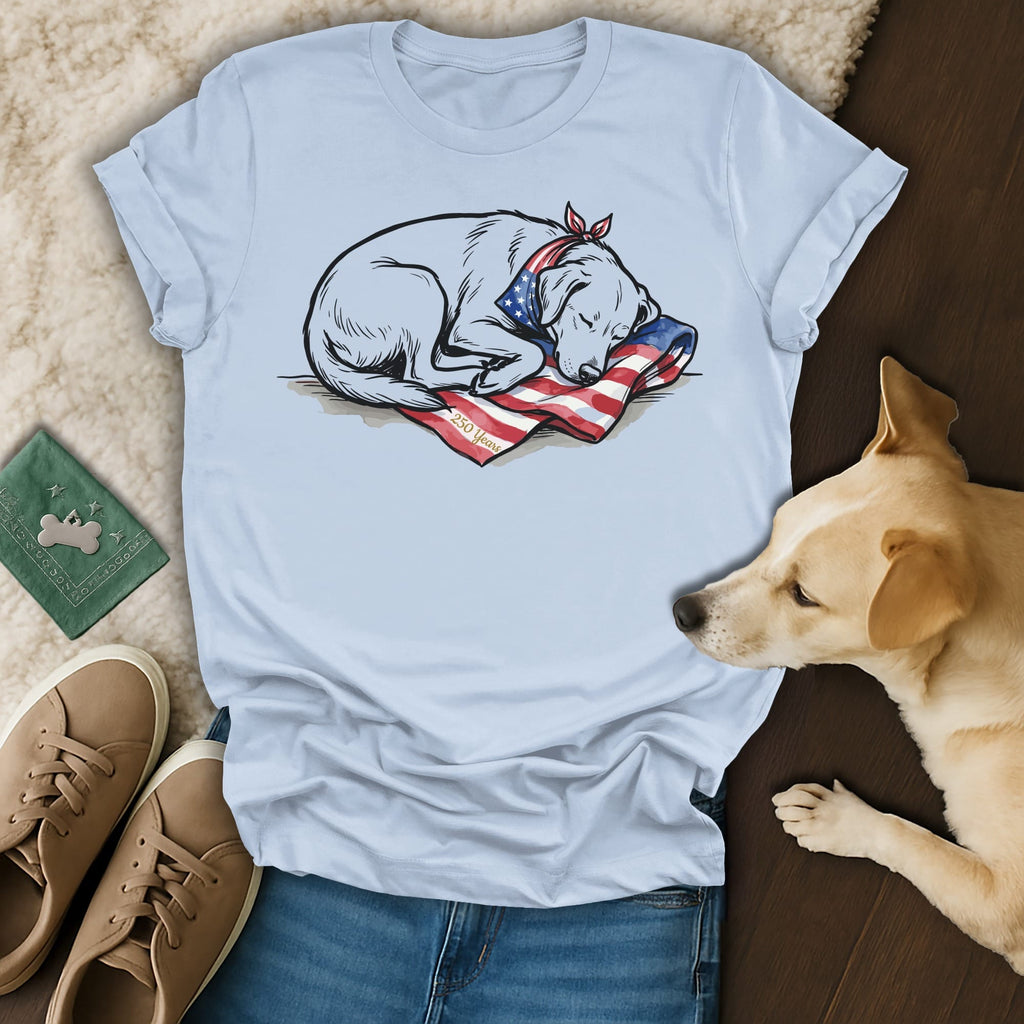 Sleeping dog wearing bandana on American flag t-shirt.