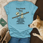 Light blue t-shirt with text about carrying a stick in the dog park.
