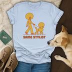 T-shirt with illustration of person walking poodle, text "SAME STYLIST".