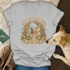 Heather gray V-neck t-shirt featuring a graphic of a dog walking through a garden gate with the text Second Chances Bloom Here.