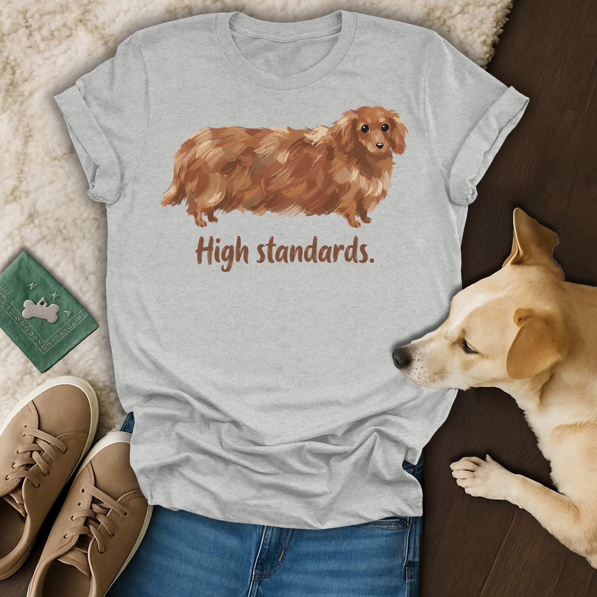 Brown dachshund t-shirt with "High standards." text, layed flat with dog and shoes.