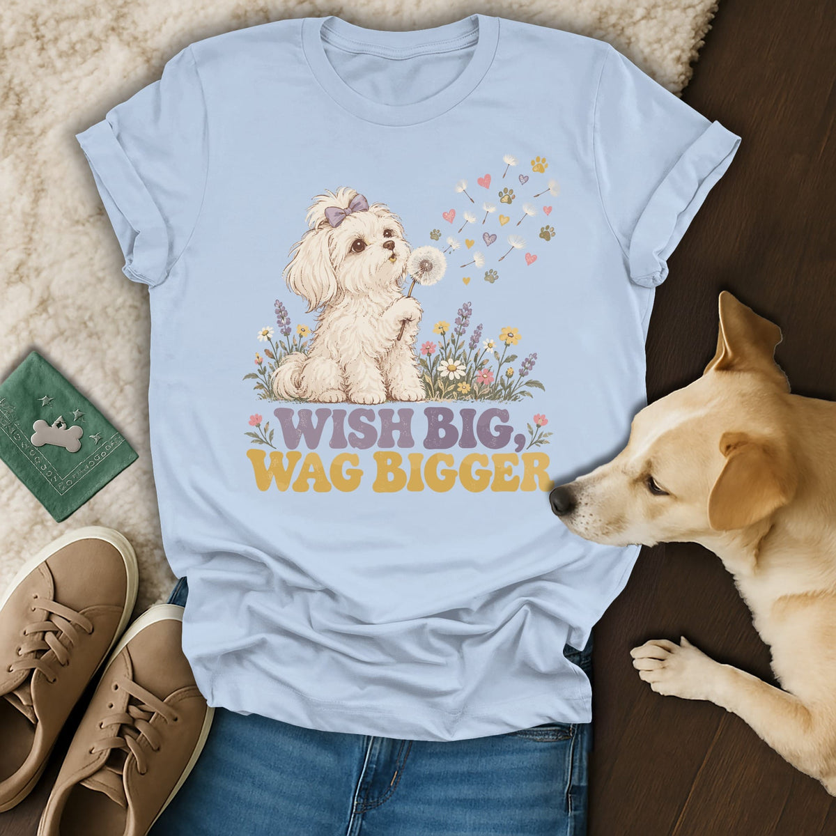 Light blue t-shirt featuring a cartoon dog, flowers, and the text Wish Big, Wag Bigger.