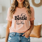 Peach t-shirt with "Bestie" and dog paw print design.