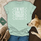 Light green t-shirt with white text "I'M NOT GOING OUT TONIGHT There's a dog there?"