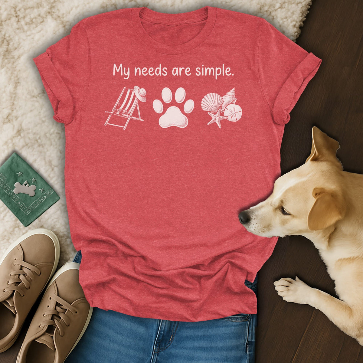 Red t-shirt with "My needs are simple" text, dog paw, and beach icons.