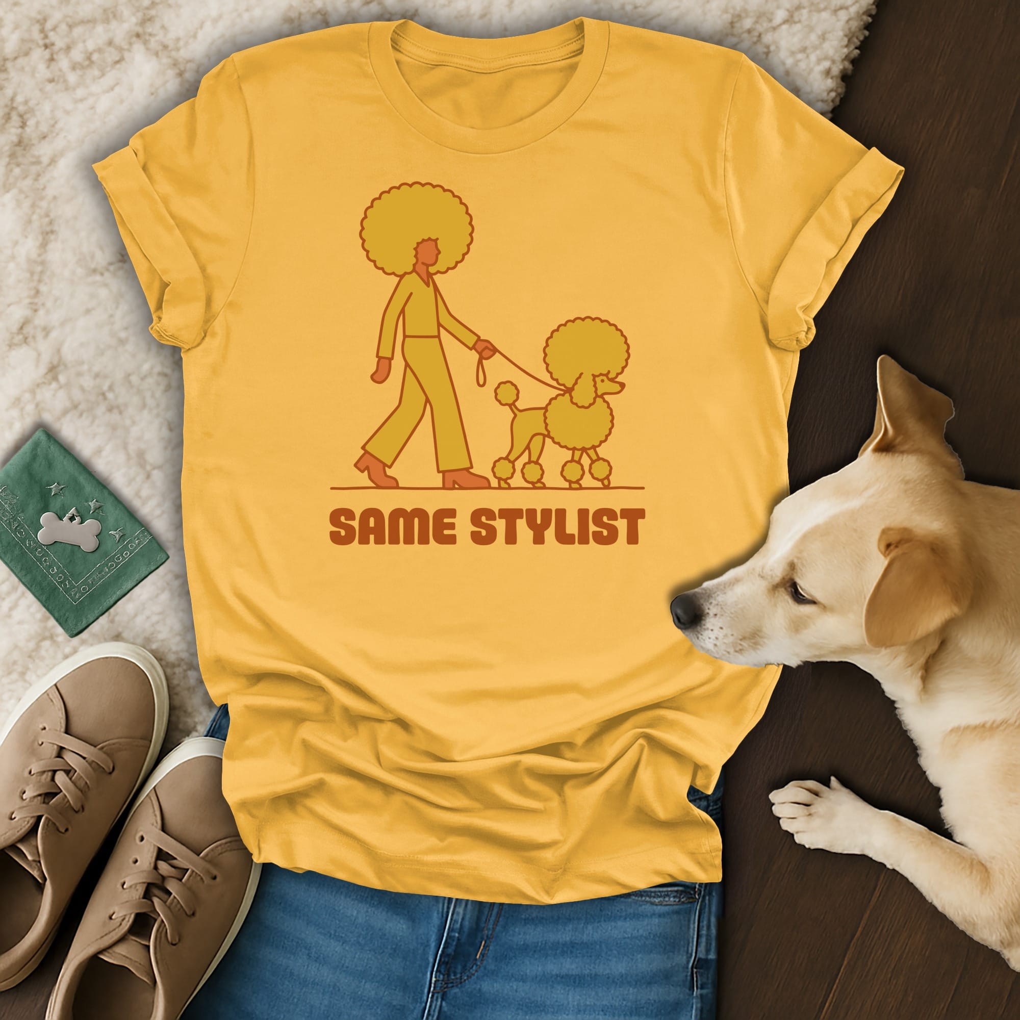 Yellow t-shirt with a graphic of a person walking a poodle, text "SAME STYLIST".