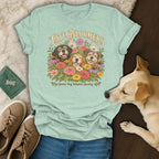 A light green t-shirt with a vintage graphic of three dogs and flowers, reading Late Bloomers Senior Dog Adoption Society.