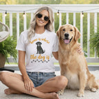 Woman and golden retriever wearing matching t-shirts with paw prints and dog silhouette.