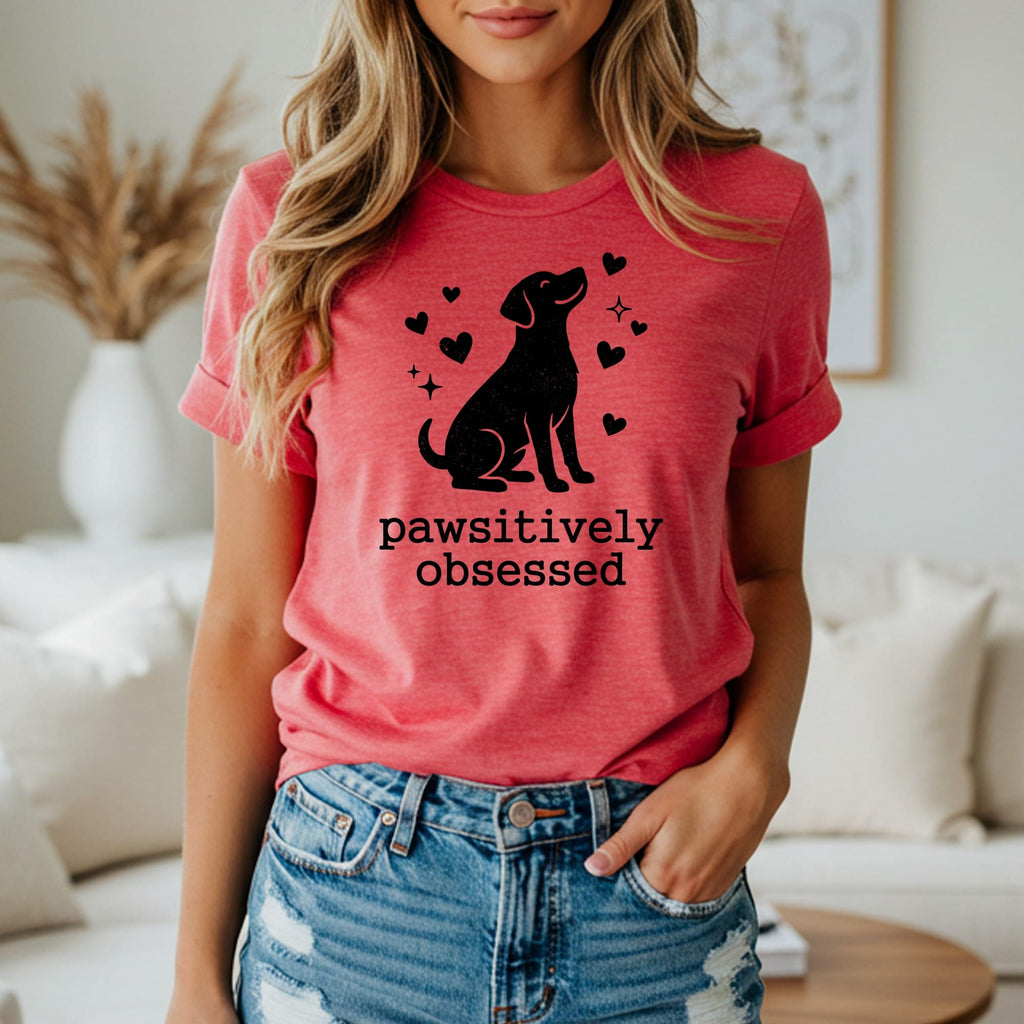 Dog silhouette with hearts and "pawsitively obsessed" text on coral t-shirt.