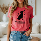 Dog silhouette with hearts and "pawsitively obsessed" text on coral t-shirt.