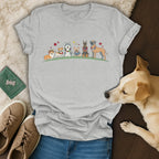 T-shirt with cartoon dogs wearing leis and flowers, standing in a line.