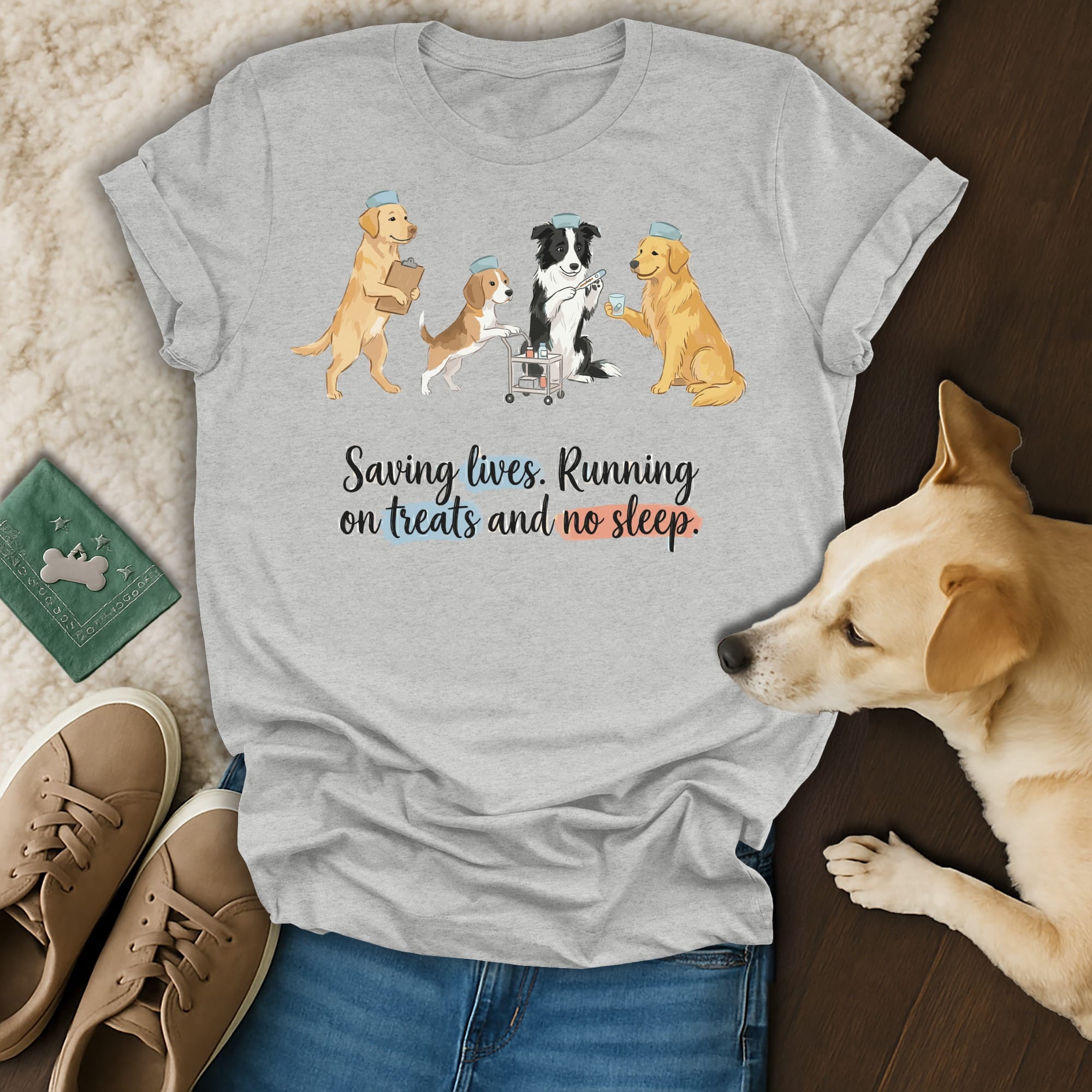 Dog nurses in scrubs and caps holding IV bag and treat box.