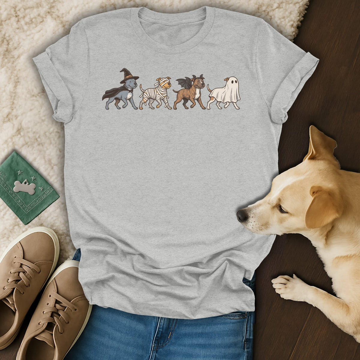 T-shirt with a Halloween-themed parade of four dogs in costumes.