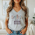 Grey t-shirt graphic with a dog and books, reading "just a book hound."