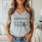 Grey t-shirt graphic of three sheep and one dog with the text "UNDERCOVER."